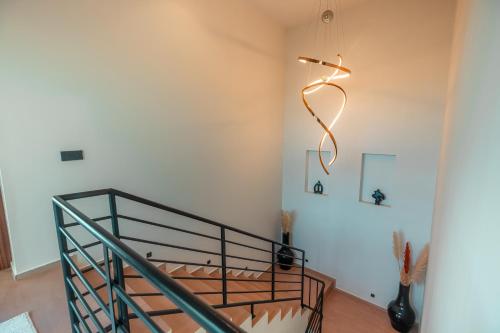 a hallway with a staircase with a light on the wall at Somptueuse Family Villa Cherifa avec piscine in Marrakech