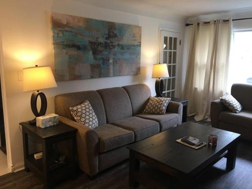 a living room with a couch and a coffee table at Comfy 3-Bedroom Home with Modern Upgrades in London