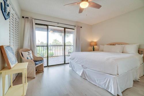 a white bedroom with a bed and a balcony at Softsands Hideaway - Portside Resort - Sleeps 6 in Panama City Beach