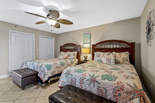 a bedroom with two beds and a ceiling fan at Gulf Peak Retreat - Watercrest 2 BR 2 BA - Sleeps in Panama City Beach