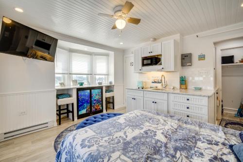 a kitchen with white cabinets and a bed in a room at Ocean City Hideaway Walk to Boardwalk and Beach! in Ocean City