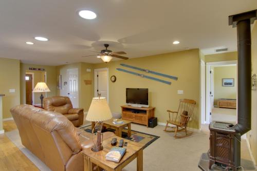 a living room with a couch and a television at Bozeman Condo with Grill about 2 Mi to Hot Springs! in Bozeman