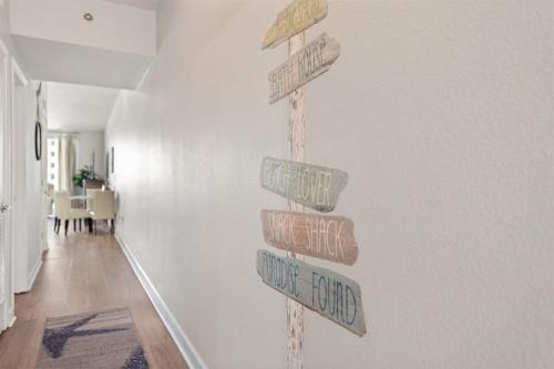 a group of wooden signs on a wall at Shores of Panama 727 - Same level parking space! in Panama City Beach