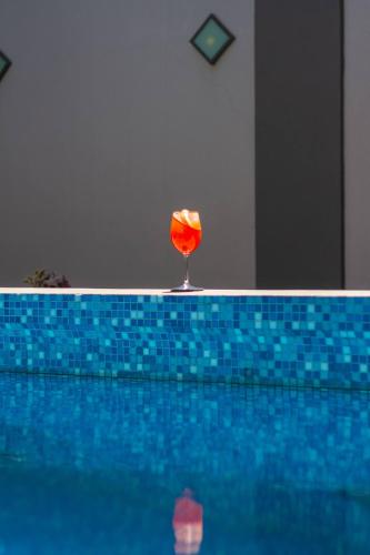 a glass of wine sitting on the edge of a swimming pool at Prodeo Hotel + Lounge in Buenos Aires