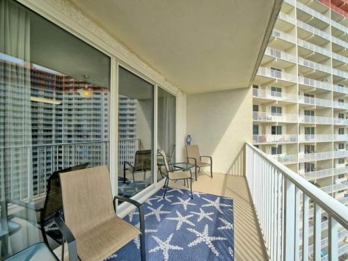 a balcony with chairs and a table on a balcony at Shores of Panama 1307, Two Masters! Under 25 ok! in Panama City Beach