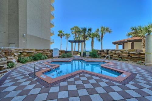 a swimming pool in the middle of a patio at Shores of Panama 1307, Two Masters! Under 25 ok! in Panama City Beach