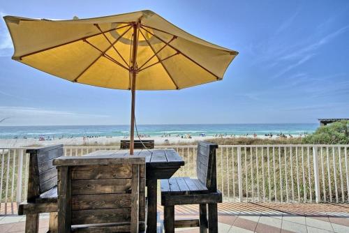 a table with an umbrella on the beach at Shores of Panama 1307, Two Masters! Under 25 ok! in Panama City Beach