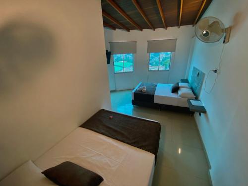 a small room with a bed and a couch at Hotel Buenos Aires Central in Medellín