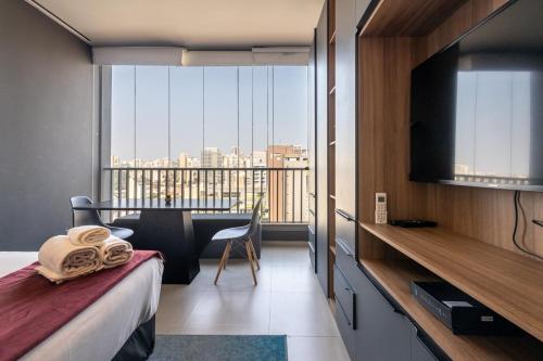a hotel room with a bed and a large window at 360 VN Turiassú by Housi in Sao Paulo