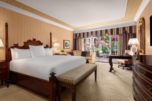 a bedroom with a large bed and a living room at Fairmont Grand Del Mar in San Diego