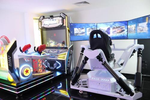 a childs stroller in front of a video game at Dreams Onyx Resort & Spa - All Inclusive in Punta Cana