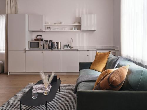 a living room with a couch and a kitchen at The Marloes in London