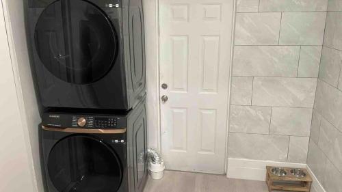 a kitchen with a black microwave and a white door at Exquisite Miami Retreat By Miami Int Airport in Miami