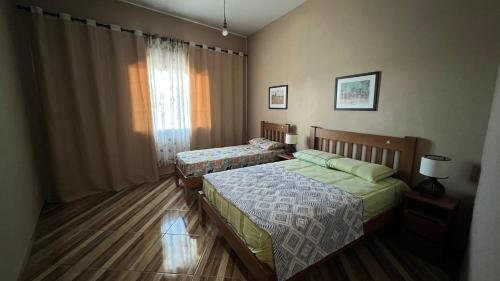 Postel nebo postele na pokoji v ubytování Chácara Giu Camacho