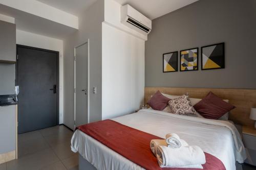 a bedroom with a bed with towels on it at 360 VN Turiassú by Housi in Sao Paulo