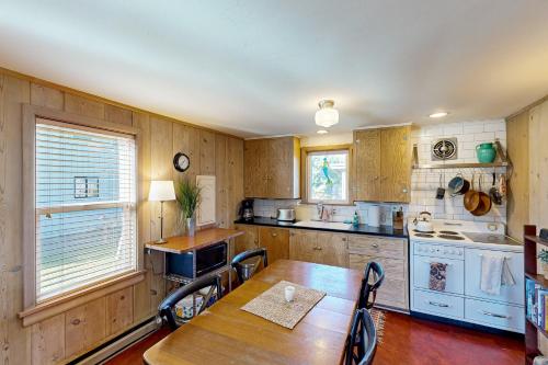 a kitchen with a wooden table and a table and chairs at Mermaid House MCA 1456 in Manzanita