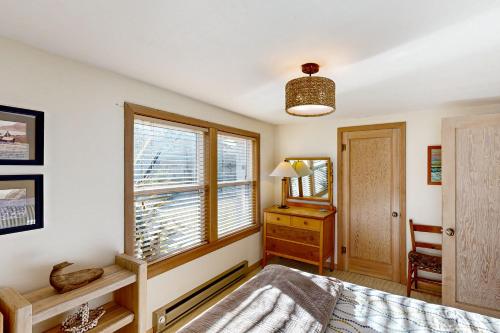 a bedroom with a bed and a dresser and a window at Mermaid House MCA 1456 in Manzanita