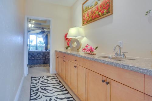 Una cocina con fregadero y encimera con lámpara. en Upscale Marco Island Villa with Outdoor Bar and Pool!, en Marco Island