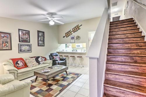 a living room with a staircase and a couch at Tallahassee Townhome 4 Mi to College Town! in Tallahassee