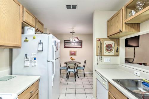 a kitchen with a table and a white refrigerator at Tallahassee Townhome 4 Mi to College Town! in Tallahassee