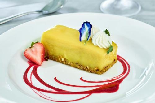 a piece of cake on a white plate with strawberries at The Ritz-Carlton St. Thomas in Benner