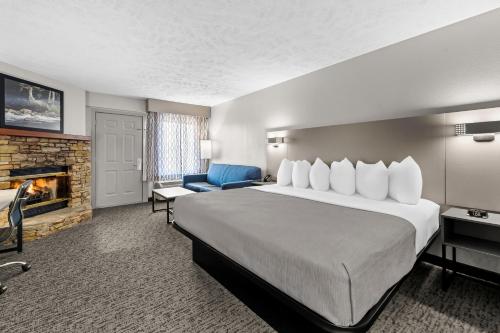 a hotel room with a large bed and a fireplace at Quality Inn & Suites at Dollywood Lane in Pigeon Forge