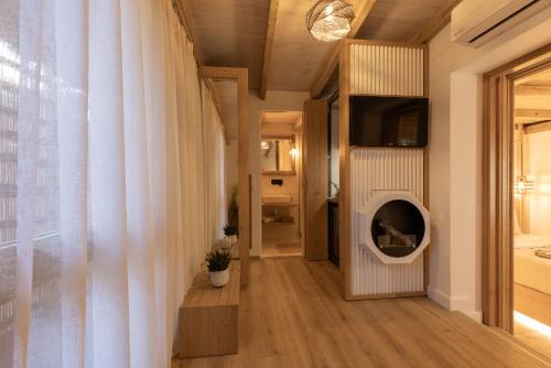 a living room with a white curtain and a window at Zoella Earth Suites in Preveza