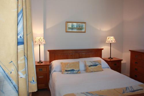 a bedroom with a bed with two lamps and two beds at Shearwater Country House Accommodation in Union Hall