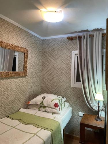 a small bedroom with a bed and a mirror at Marbella Apartment in Marbella