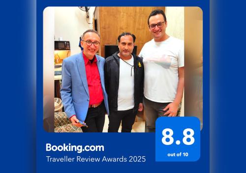 a group of three men posing for a picture at Youth Palace Hostel هوستل قصر الشباب in Alexandria