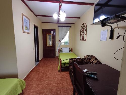 a living room with a couch and a bed at Hotel Valle Verde in Valle de Anton
