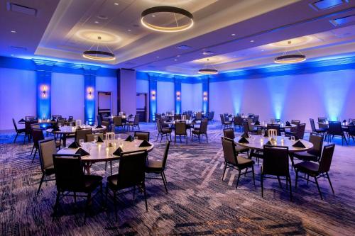 a banquet hall with tables and chairs in a room at Boston Marriott Peabody in Peabody