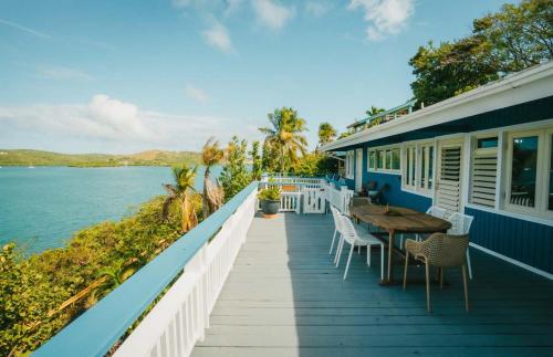 a porch of a house with a table and chairs at AMAZING Bay View Marea 2-2 in Culebra