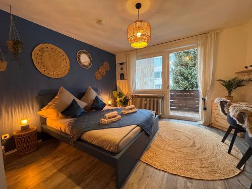 a bedroom with a bed and a window at BOHO Apartment Zirbe Blue in Bad Reichenhall