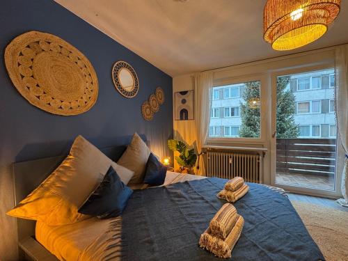 a bedroom with a large bed with pillows and a window at BOHO Apartment Zirbe Blue in Bad Reichenhall