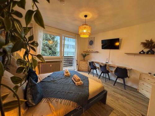 a bedroom with a bed and a desk with chairs at BOHO Apartment Zirbe Blue in Bad Reichenhall