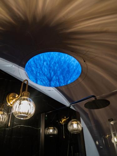 a round window in the ceiling of a room with lights at Cromore Retreat in Portstewart