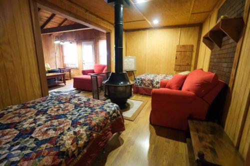 a bedroom with a bed and a stove in a room at That 70s Cabin Yellow Rose Canyon in Mount Enterprise
