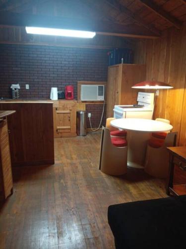 a kitchen with a table and a counter top at That 70s Cabin Yellow Rose Canyon in Mount Enterprise