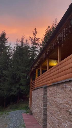 a brick house with a sunset in the background at Hidden Valley in Muntele Cacovei