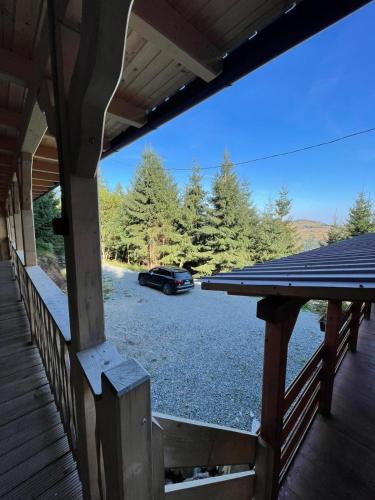 a car parked in a parking lot next to a porch at Hidden Valley in Muntele Cacovei