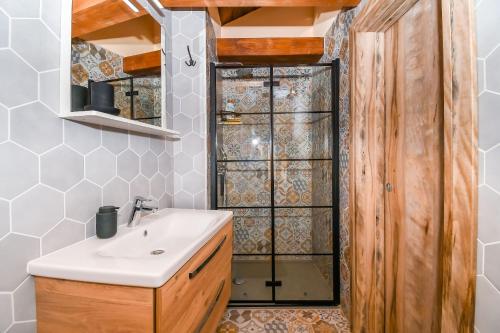 a bathroom with a sink and a shower at House Morski brk in Trogir