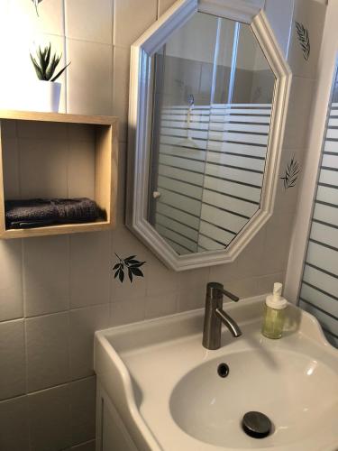 une salle de bain avec un lavabo et une fenêtre dans l'établissement Duplex au coeur du village, à Piana