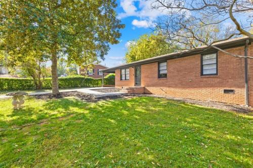 a brick house with a lawn in front of it at 2 bathroom, downtown Davidson - La Casita in Davidson