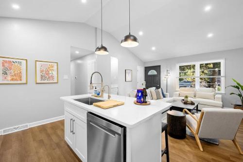 a kitchen with a sink and a living room at 2 bathroom, downtown Davidson - La Casita in Davidson