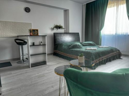 a bedroom with a green bed and a couch at Cataleya Luxury Room's in Bucharest