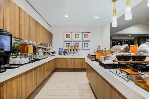 a restaurant with a counter with a lot of food at Homewood Suites by Hilton Plano-Richardson in Plano