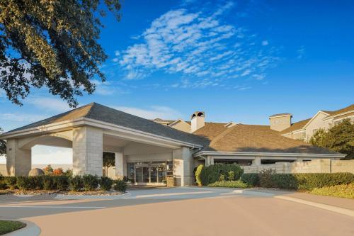 a house with a driveway in front of it at Homewood Suites by Hilton Plano-Richardson in Plano