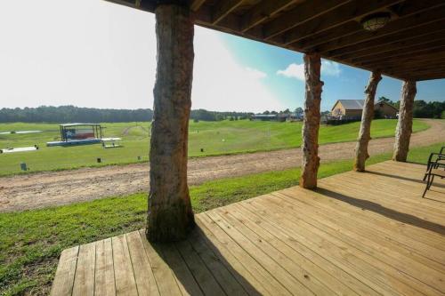 a wooden porch with a view of a golf course at Barn 1 Yellow Rose Canyon in Mount Enterprise