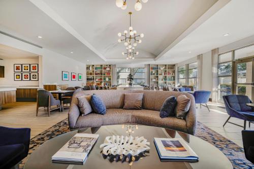 a living room with a couch and a table at Homewood Suites by Hilton Plano-Richardson in Plano